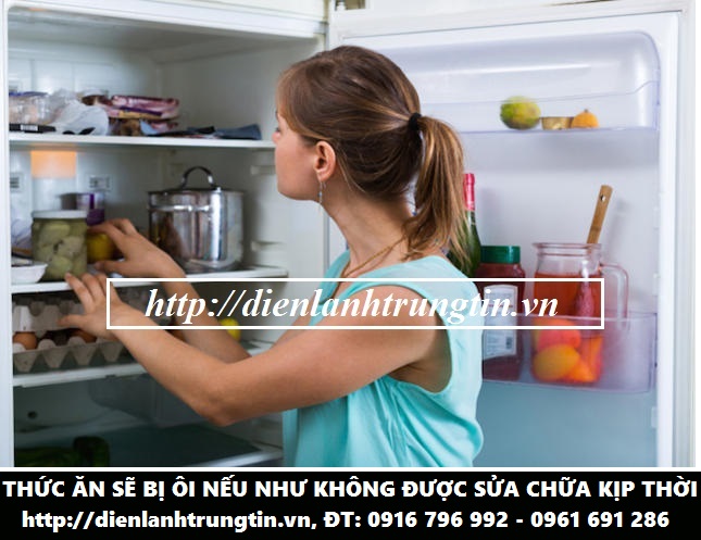 Young woman standing near refrigerator filled with products